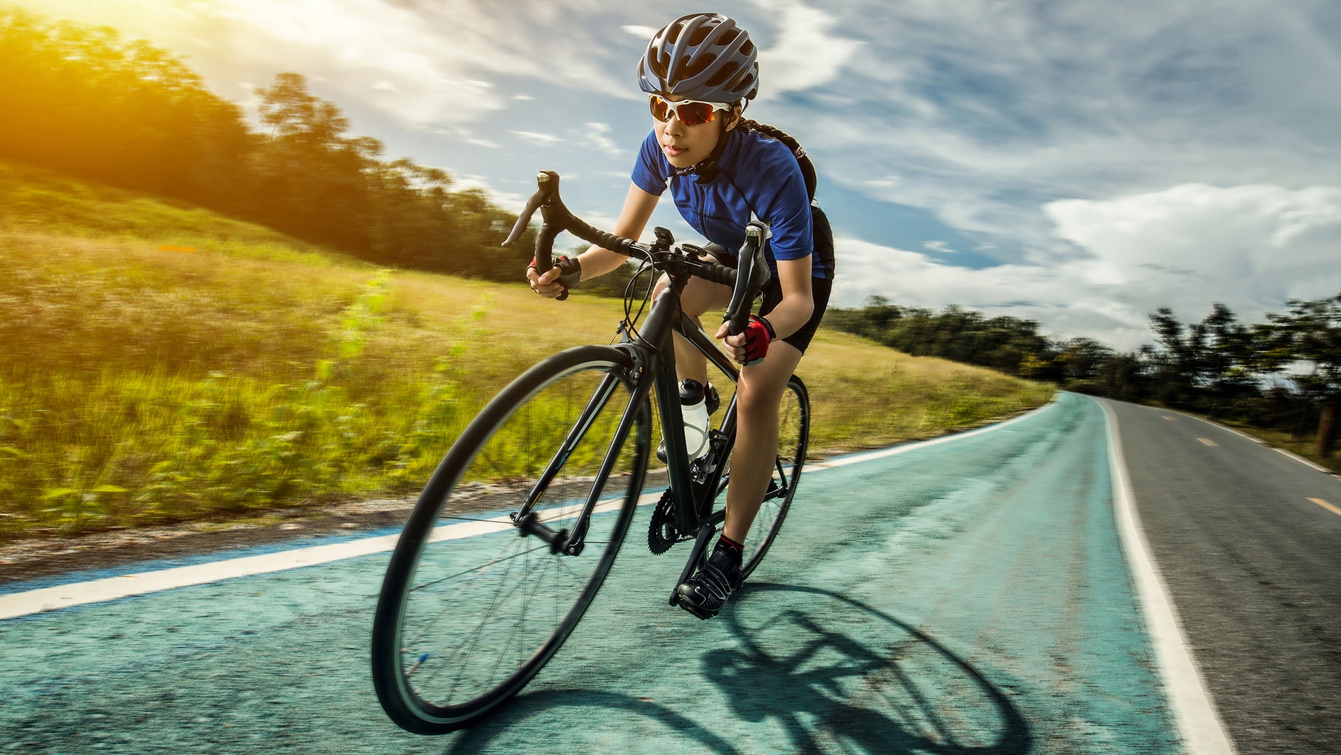A boy riding a cycle across the road
